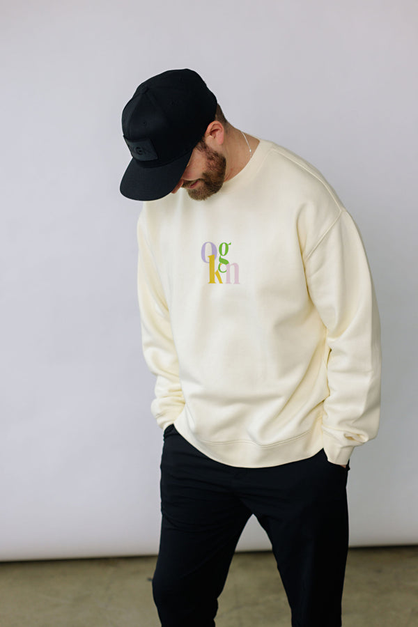 Oversized off-white crewneck with pastel lettering showcasing a redesigned OKGN on the front and LIFESTYLE on the back. This is an 80/20 Cotton Poly blend.