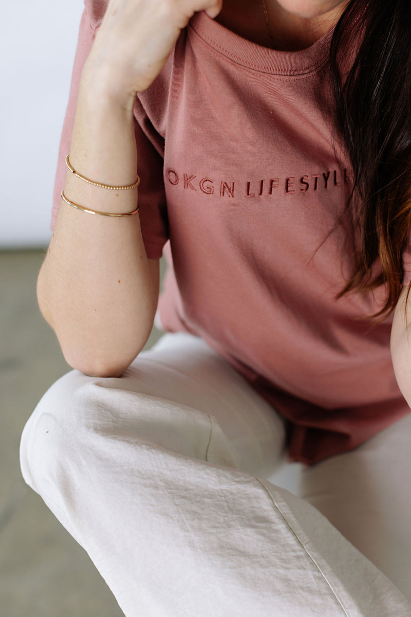 Soft Cotton Blend t-shirt with our OKGNLIFESTYLE moniker embroidered in dusty rose, tone on tone