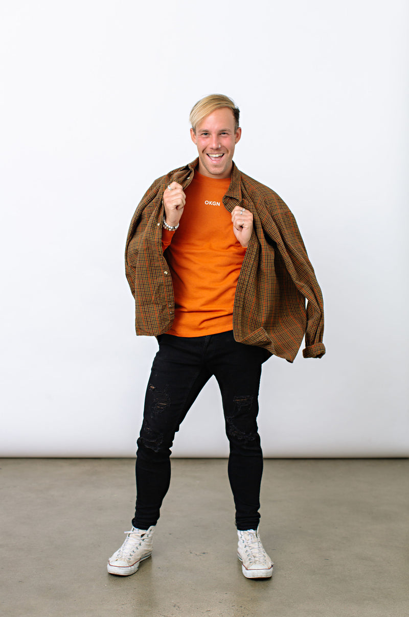 Okanagan Lifestyle orange long sleeve shirt with LIFE printed in white on back