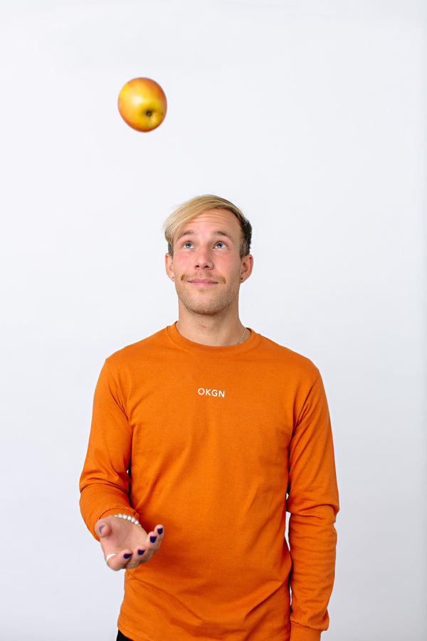 Okanagan Lifestyle orange long sleeve shirt with LIFE printed in white on back