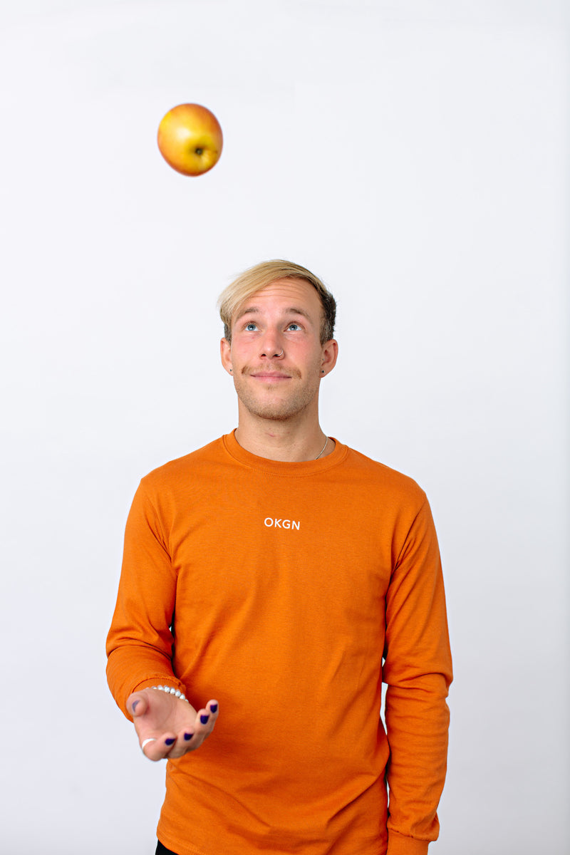 Okanagan Lifestyle orange long sleeve shirt with LIFE printed in white on back
