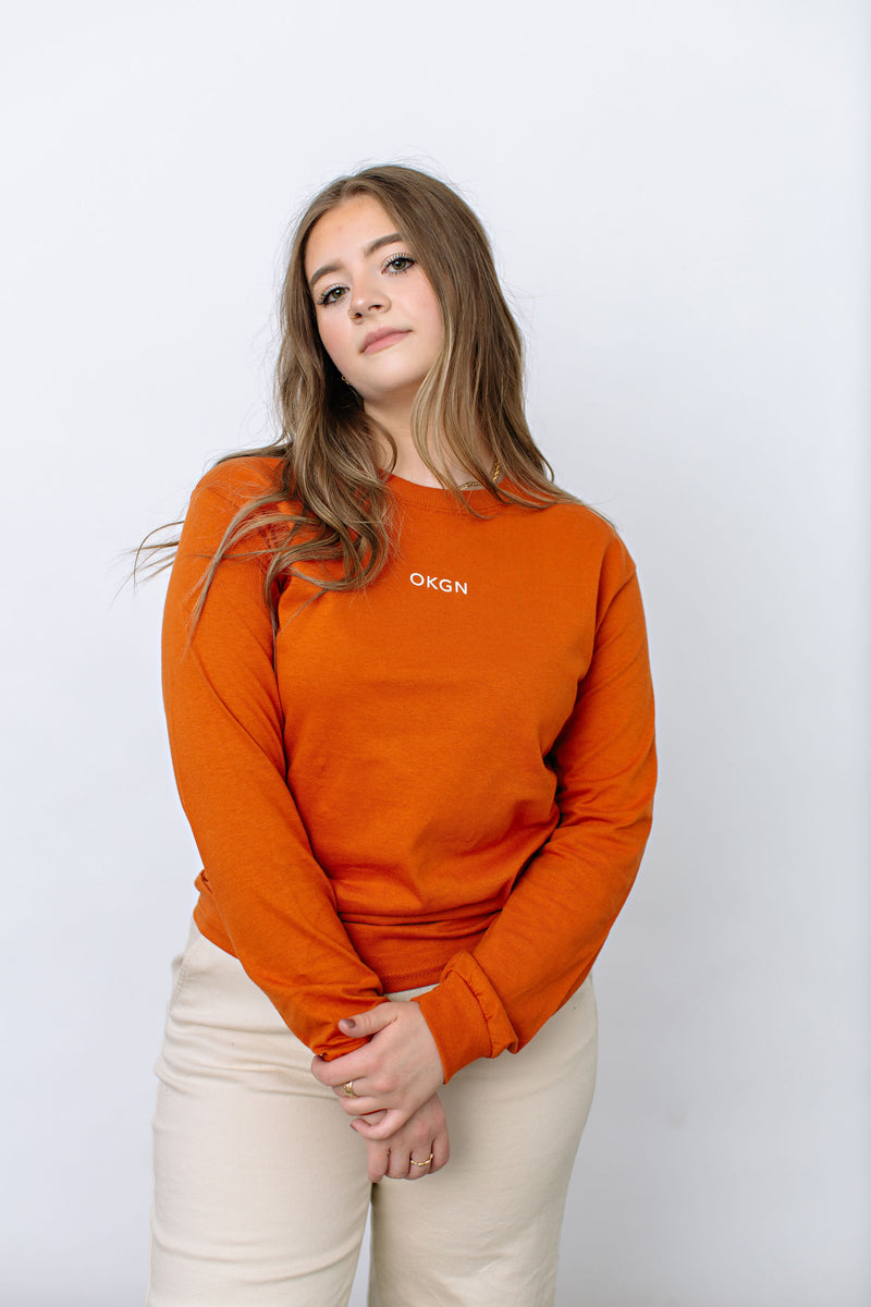 Okanagan Lifestyle orange long sleeve shirt with LIFE printed in white on back